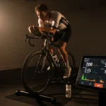 Cycling Power Zones Guide: FTP Science, Training Zone Breakdown, and How to Structure Every Ride cyclist performing FTP ramp test indoor trainer power meter display watt output test cycling training photography