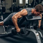 Chest-Supported Row: The Back Thickness Exercise That Eliminates Lower Back Compensation and Isolates the Upper Back person performing chest-supported dumbbell row incline bench back isolation upper back rhomboid lat mid-trapezius